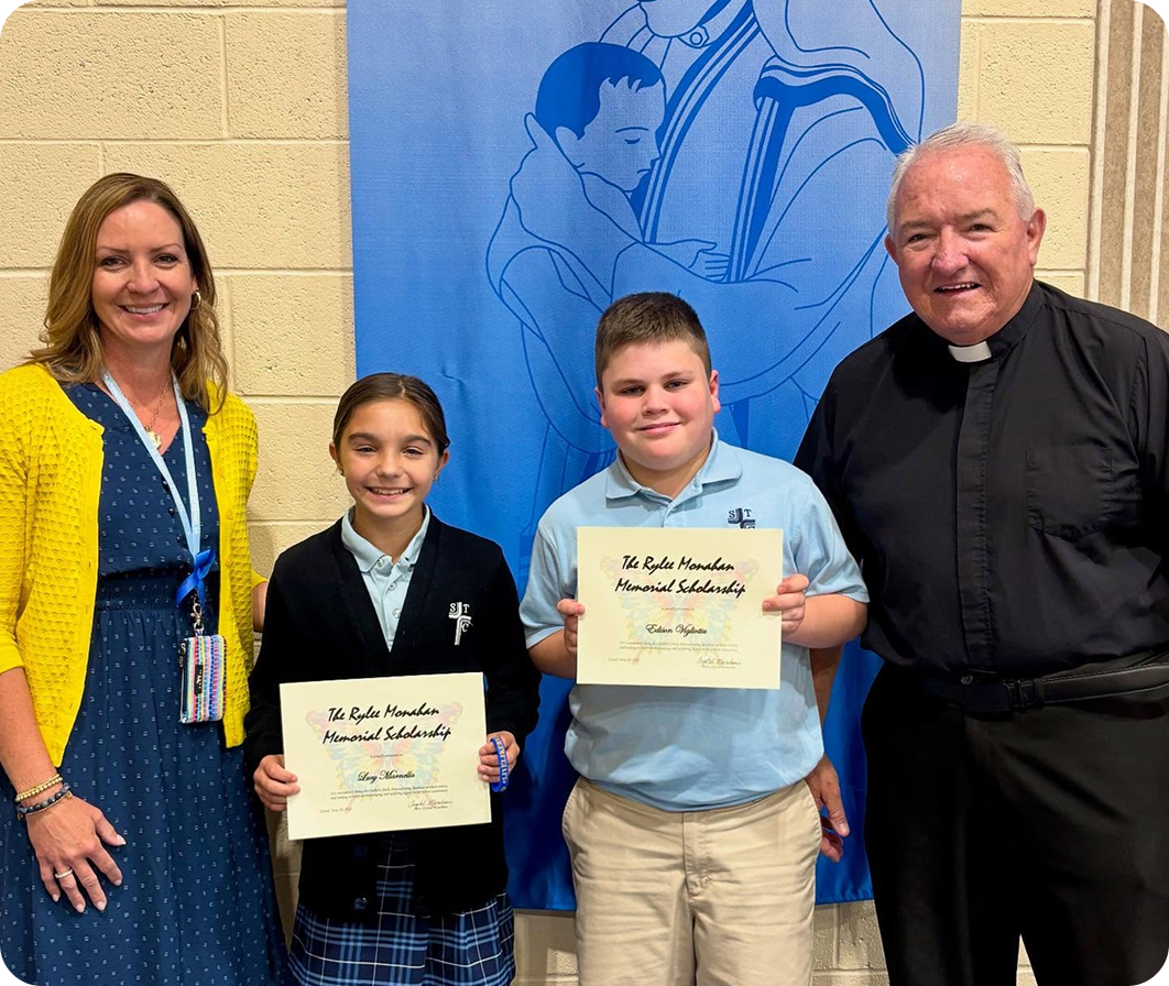 Two scholarship winners from STC holding their certificates with Crystal and Fr. Brandt